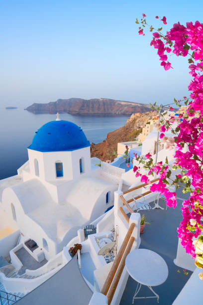 traditional greek village Oia of Santorini, with blue domes of churches and village roofs, Greece