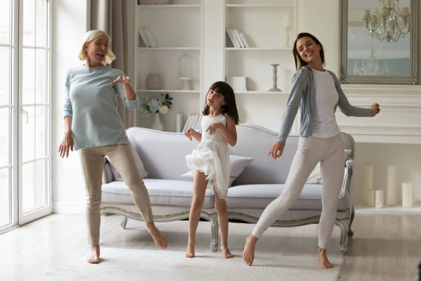 istock Happy three generations of women having fun, dancing together 2169939343
