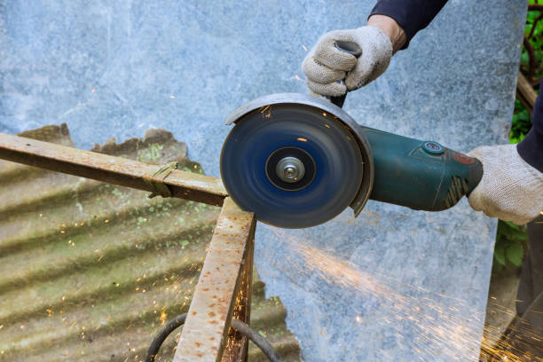 istock During cutting of metal frames, a worker uses an angle grinder hand saw 2169942054