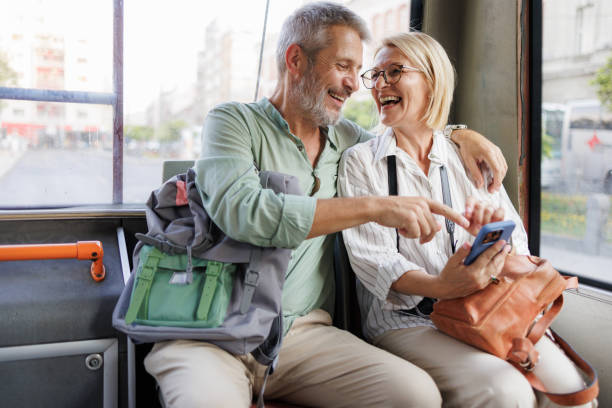 istock Mature couple using smart phone while traveling on a city bus 2169942180