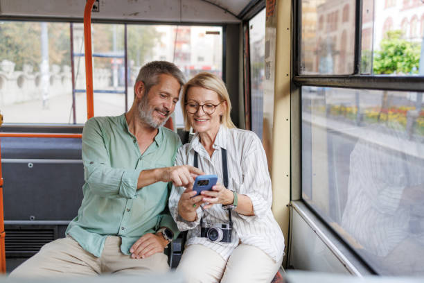 istock Mature couple using phone while traveling on a city bus 2169942181