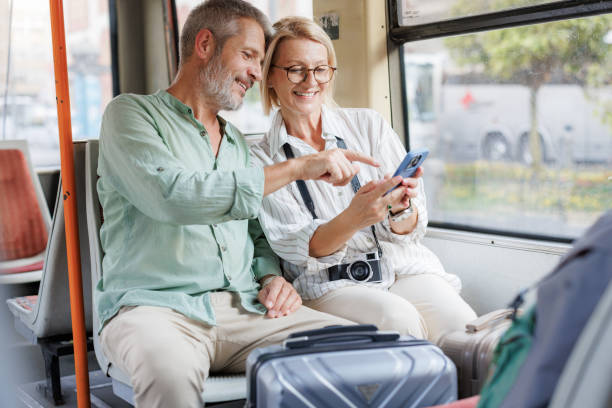 istock Mature couple using phone in public transportation while traveling 2169942271