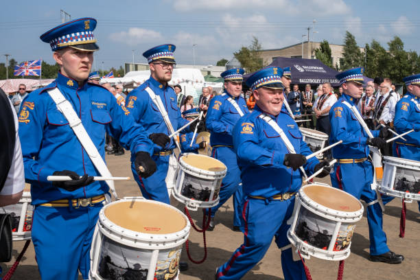 Vroomshoop, Twenterand, Overijssel, Netherlands, april 30th 2013, members of the local fanfare orchestra wearing uniforms with hats, drumming and marching at the traditional festivities on Koninginnedag (Queen's day) at the market square in Vroomshoop