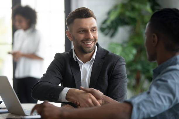istock Happy manager shaking hands with client in modern bank office 2169942833