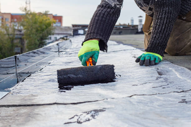 istock a young worker treats a roof with bitumen primer before applying rolled asphalt roofing using a torch 2169943223