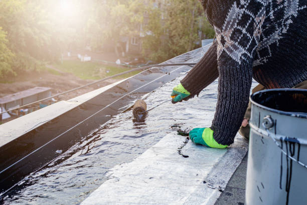 istock a young worker treats a roof with bitumen primer before applying rolled asphalt roofing using a torch 2169943225