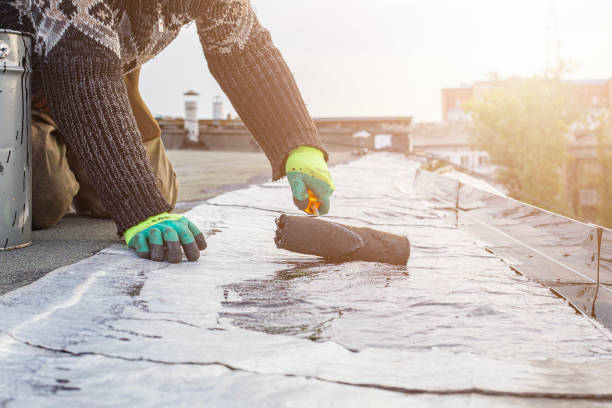 istock a young worker treats a roof with bitumen primer before applying rolled asphalt roofing using a torch 2169943226