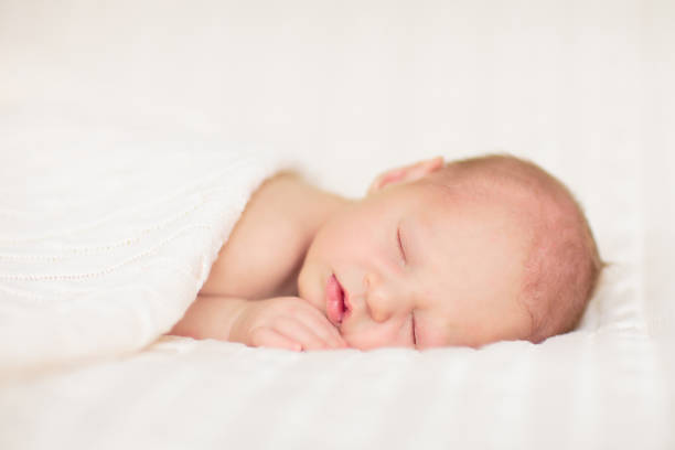istock Little baby on white bed 2169943267