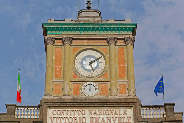 Naples, Italy - June 25, 2014: Public Clock and Bells at Top of Convitto Nazionale Vittorio Emanuele Historic Building at Piazza Dante.