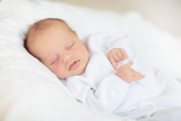 istock Little baby on white bed 2169944360