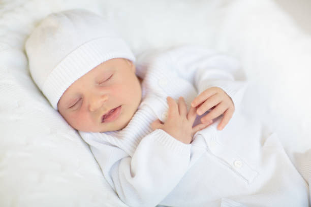 istock Little baby on white bed 2169944386