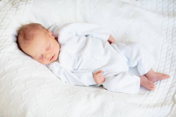 istock Little baby on white bed 2169944473