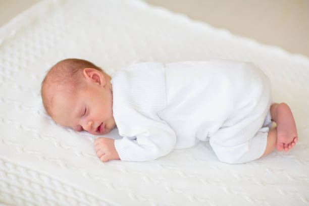 istock Little baby on white bed 2169944643