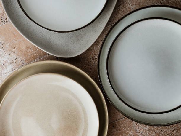 Top view of modern various ceramic plates on a kitchen table, cooking concept.