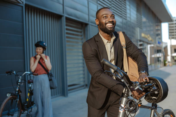 istock Confident businessman commuting with bicycle in urban setting 2169944934
