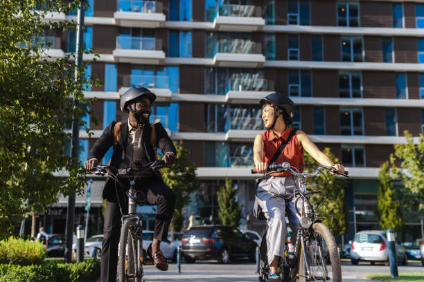istock Two colleagues biking to work enjoy a sunny morning commute 2169944951