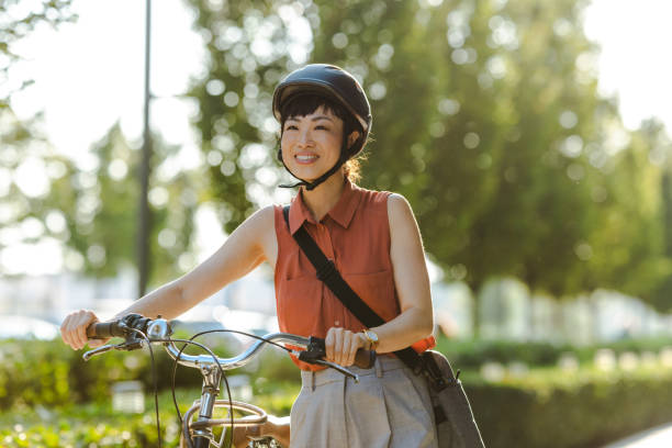 istock Smiling Japanese female commuter with her bicycle 2169945099