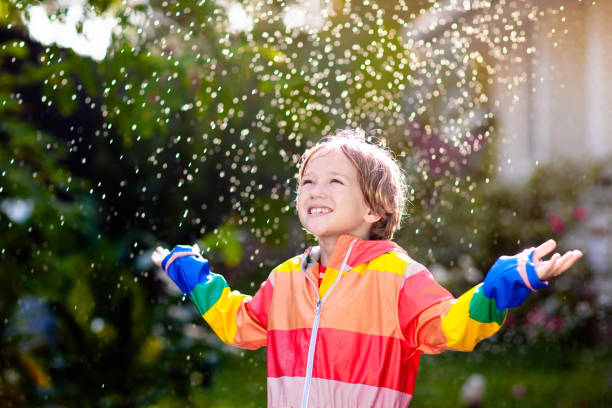 istock Child playing in autumn rain. Kid with umbrella. 2169945546