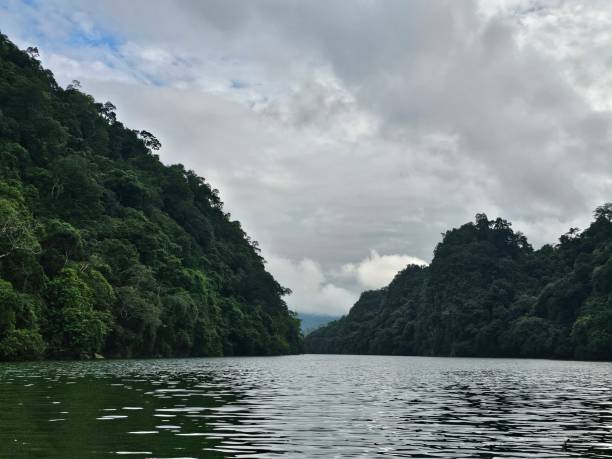 istock Forested Hills and Calm Waters Under an Overcast Sky 2169945716