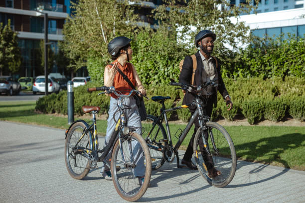 istock Two friends enjoying a walk with bicycles in urban setting 2169945728