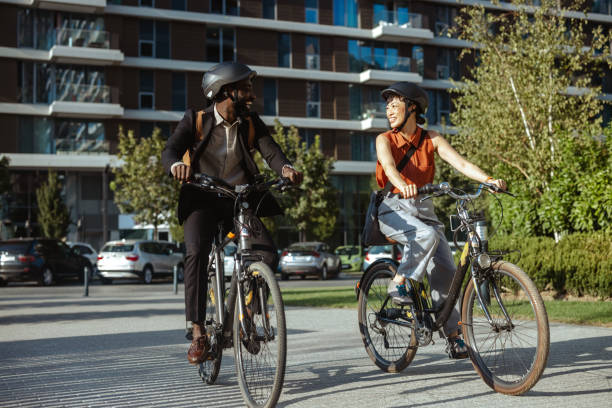 istock Two colleagues biking to work enjoy a sunny morning commute 2169945792
