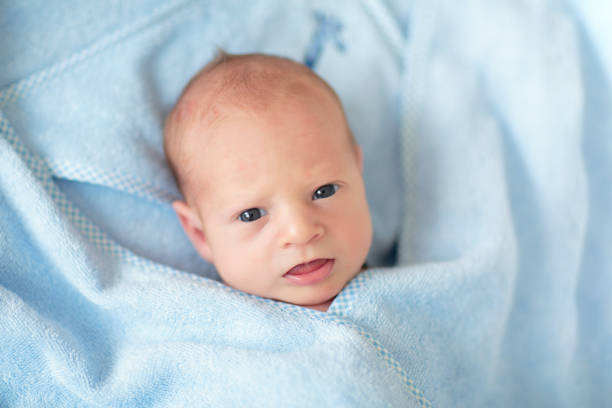 istock Little baby in blue towel 2169945800
