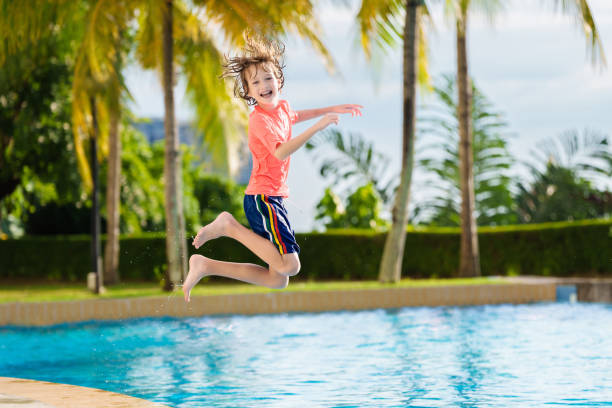 istock Kids jump into swimming pool. Summer water fun. 2169945848