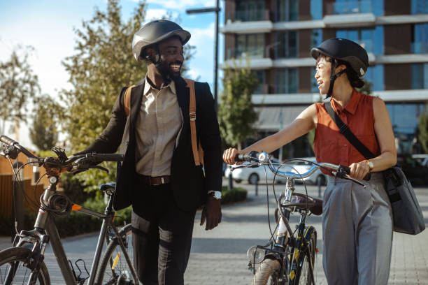istock Two friends enjoying a walk with bicycles in urban setting 2169945857