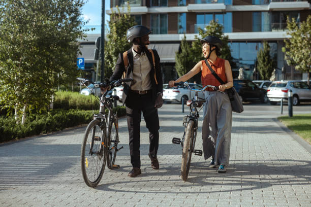 istock Two friends enjoying a walk with bicycles in urban setting 2169945858