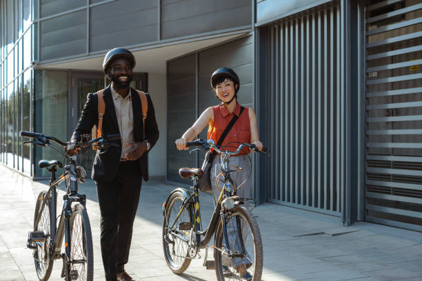 istock Two coworkers enjoying a walk with bicycles in urban setting after work 2169945946