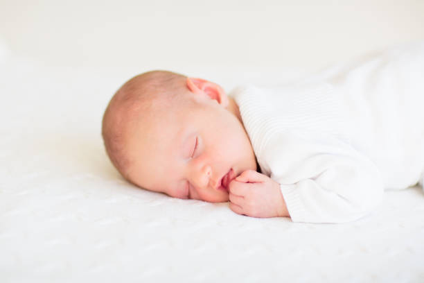 istock Little baby on white bed 2169946019