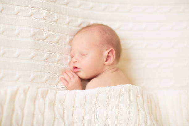 istock Little baby on white bed 2169946161
