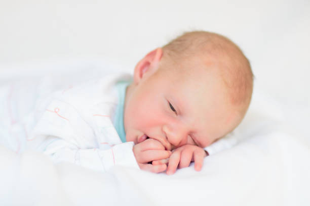 istock Little baby on white bed 2169946166