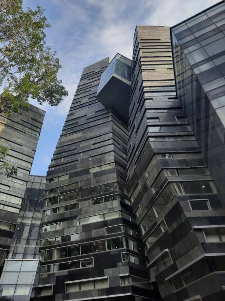 istock Unique Modern eco-friendly glass architecture facade and green trees against blue sky. University of Indonesia building facade. 2169946248