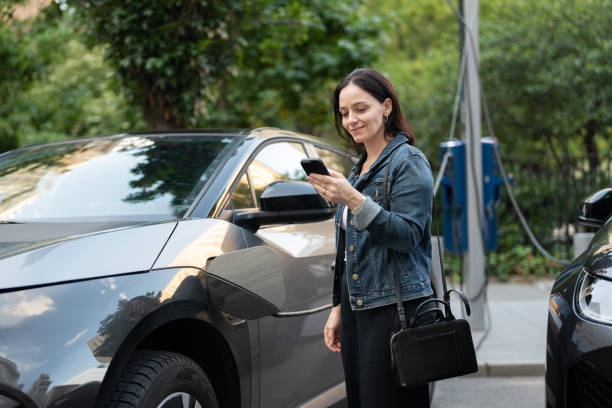 istock Woman at a Public EV Charging Station 2169946454