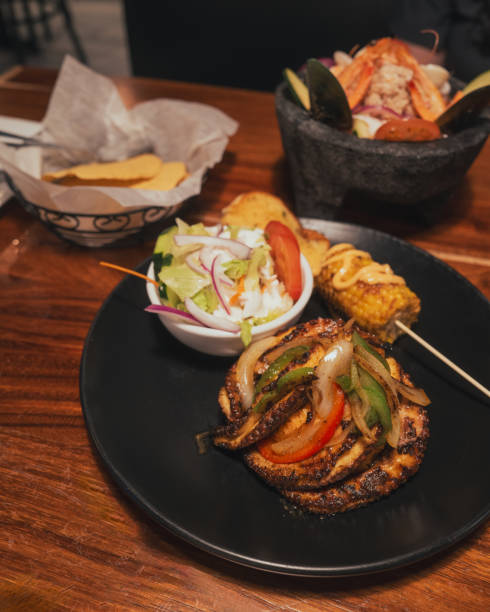 istock Grilled Octopus over Rice - Mexican Seafood Restaurant - Chips, Ceviche, Corn, Salad - Vertical 2169946492