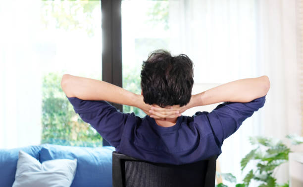 istock Work from home, Stretch for relax, Young man stretching body while working with laptop computer at desk home office, Back of male student raised arms take rest from online education 2169948365
