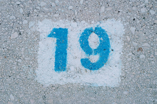 istock Number nineteen painted on the asphalt in a white rectangle 2169948883