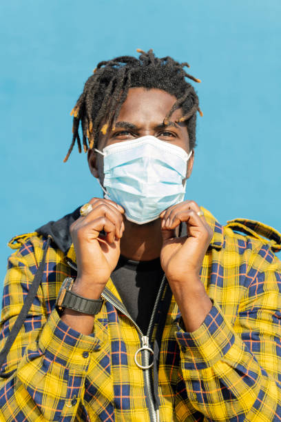 istock young african man wearing a protective mask 2169951212