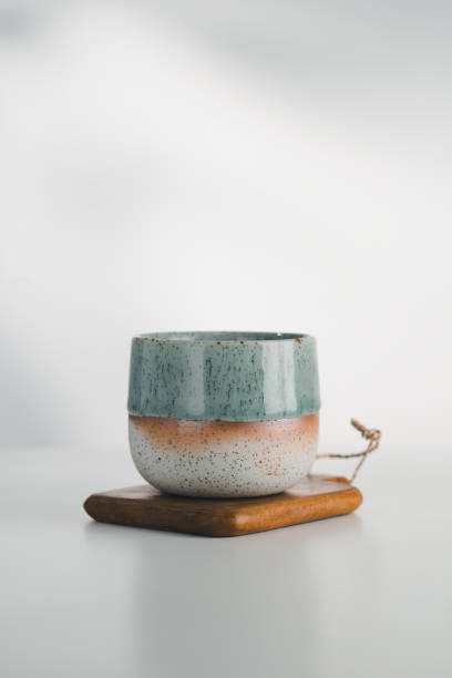 istock A dual-glazed ceramic cup rests on wood. 2169952782
