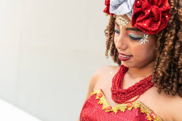 Woman looking down in a red carnival costume with festive makeup