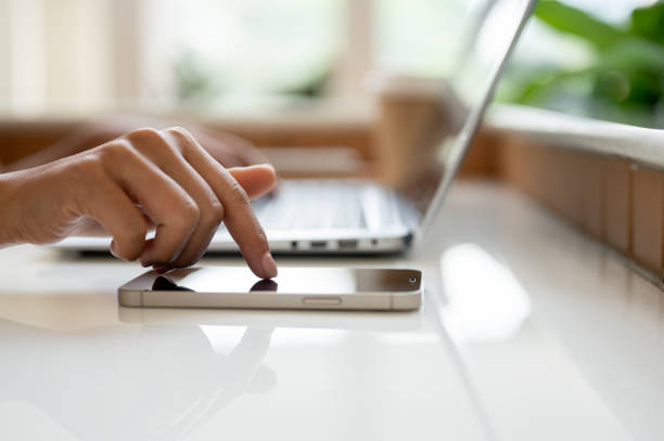 istock A close-up image of a woman's finger touching on a smartphone screen on a table. 2169960256
