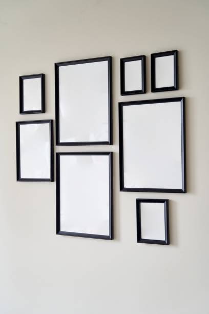 istock Different size framed photos hanging on the gray wall. Mockup. 2169960595