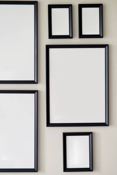 istock Different size framed photos hanging on the gray wall. Mockup. 2169960648