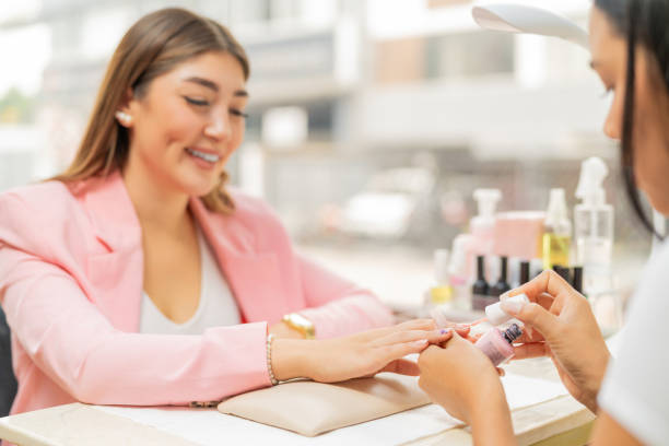 istock Smiling client in a beauty salon painting her nails 2169963283