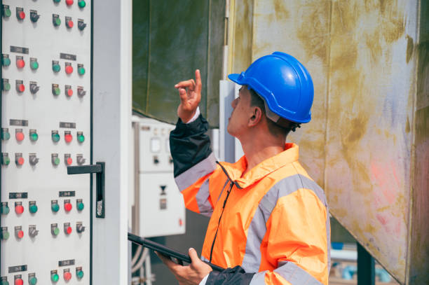 istock The electrician inspects a large-scale industrial electrical control system, focusing on the safety and stability of the electrical system. 2169964302