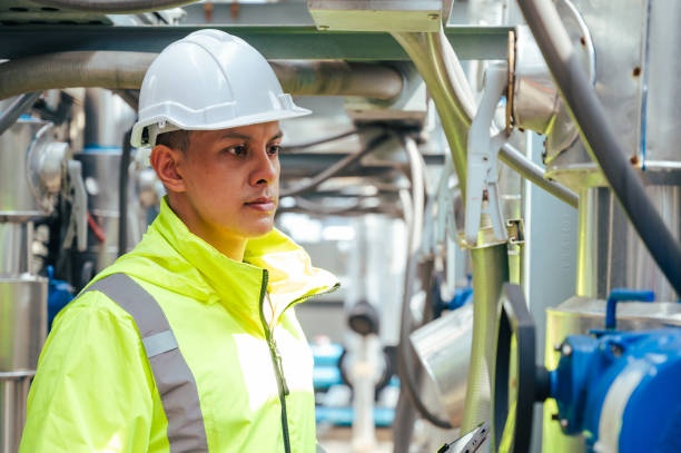 istock The technician carefully inspecting a section of pipeline during a construction project, emphasizing safety and precision in infrastructure development. 2169964310