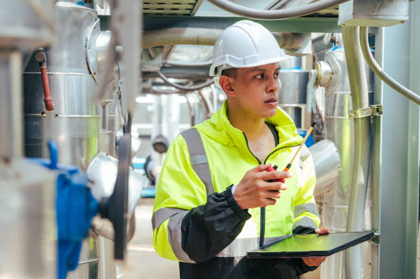 istock The technician carefully inspecting a section of pipeline during a construction project, emphasizing safety and precision in infrastructure development. 2169964313