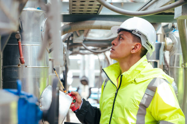 istock The technician carefully inspecting a section of pipeline during a construction project, emphasizing safety and precision in infrastructure development. 2169964314