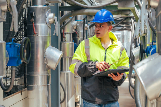 istock The technician carefully inspecting a section of pipeline during a construction project, emphasizing safety and precision in infrastructure development. 2169964321